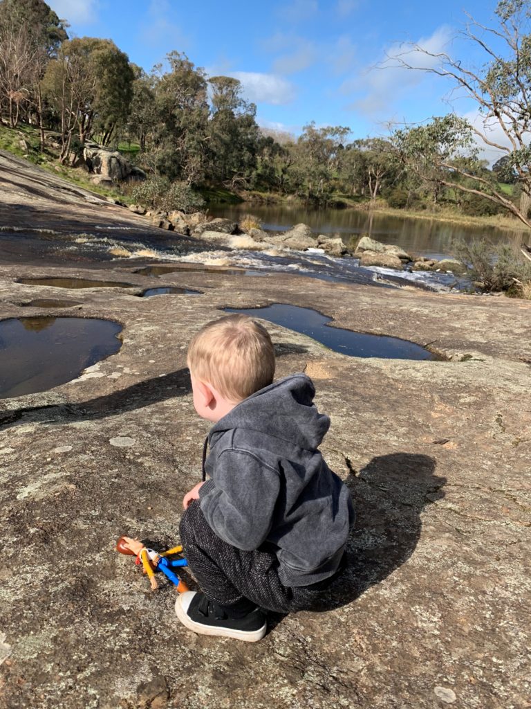 A photo of a child looking out over Polly McQuinns swimming hole in the Strathbogie Ranges.
